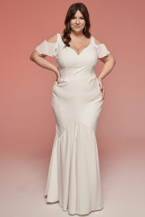 Suknia ślubna w kolorze białym z odkrytymi ramionami i dopasowanym fasonem.