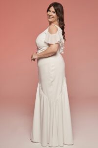 suknia ślubna z odkrytymi ramionami i falbankami, w kolorze białym, z dopasowaną górą i rozkloszowanym dołem