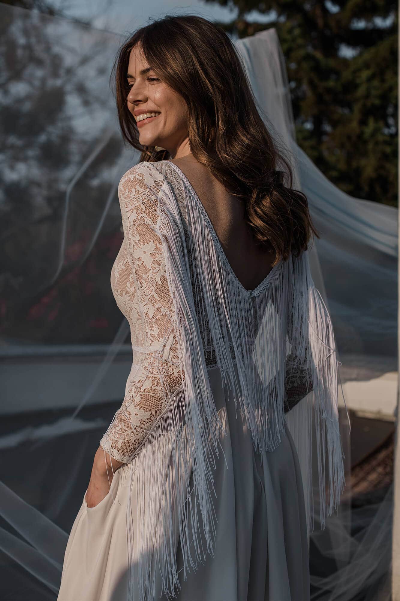 suknia ślubna z długimi rękawami, koronkowym wzorem i zwiewnym trenem