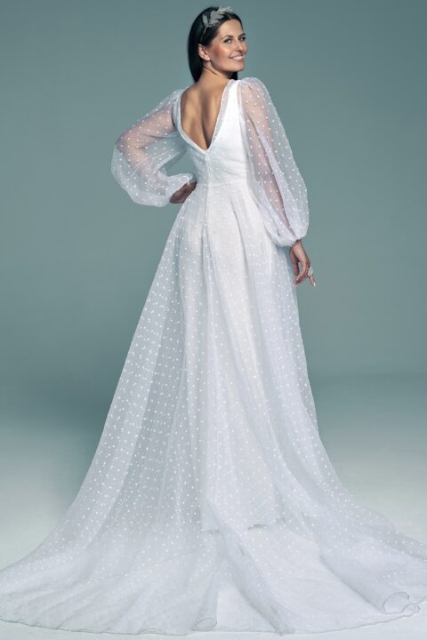 suknia ślubna z długimi, przezroczystymi rękawami i falbaną na dole, w kolorze białym.