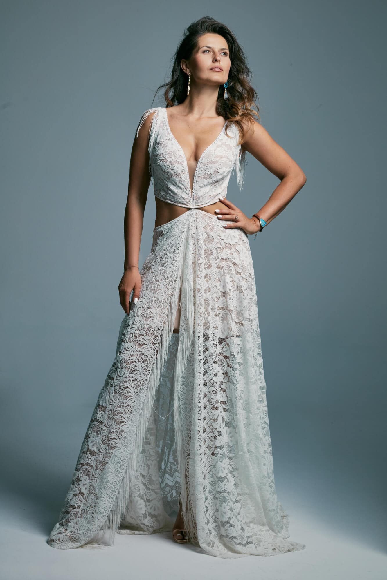 suknia ślubna z koronkowymi detalami, z odkrytymi ramionami i rozcięciem z przodu