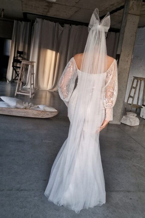suknia ślubna z długimi rękawami i welonem, widok od tyłu w jasnym wnętrzu