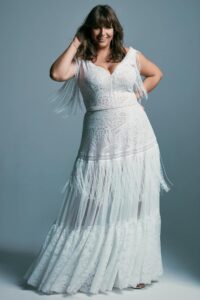 suknia ślubna z koronkowym topem i falbanami na dolnej części.